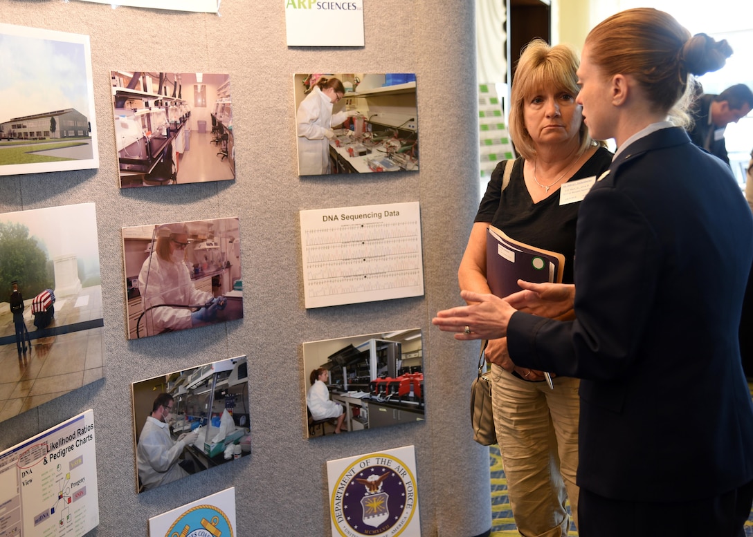 Air Force Lt. Col. Alice Briones, Armed Forces Medical Examiner System Department of Defense DNA Registry director, explains the Armed Forces DNA Identification Laboratory mission to Debra Eschenbacher, cousin of Air Force Airman 1st Class Alvin Hart, Jr., Aug. 11, 2016, at the Korean/Cold War Annual government briefings in Arlington, Virginia. AFDIL plays a vital role in the identification process. 