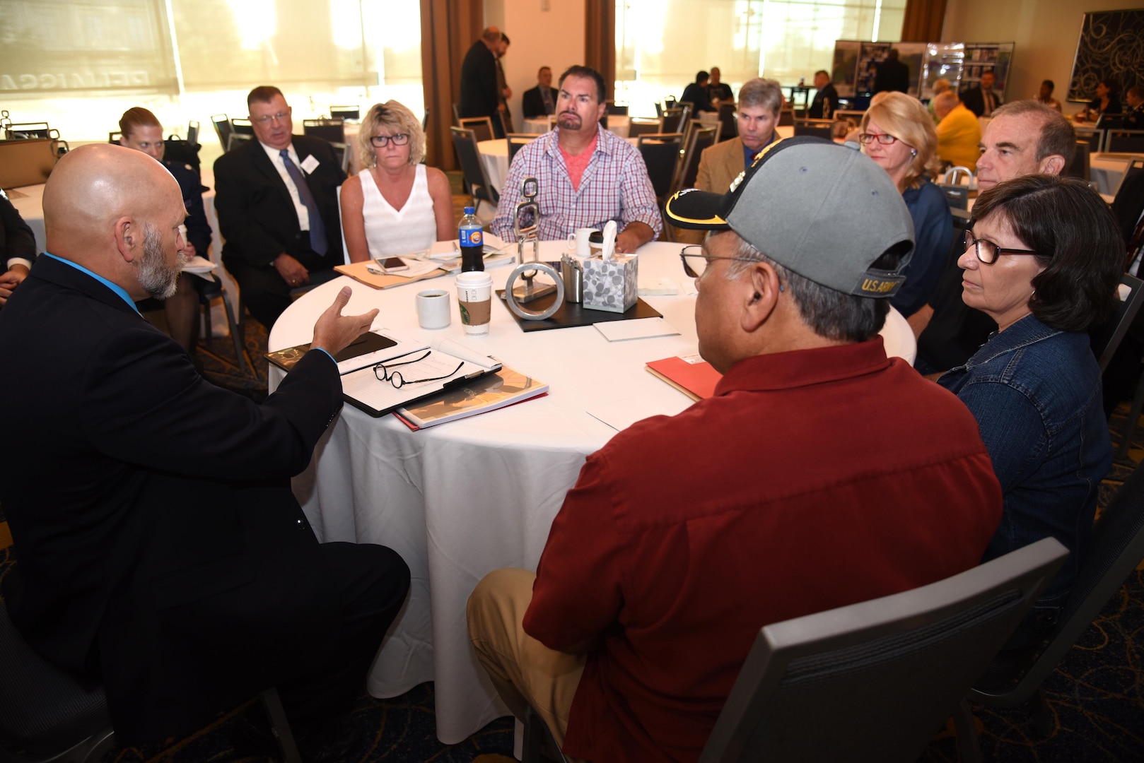 William “Shorty” Cox, U.S. Army Casualty Office of Past Conflict Registration Branch identification specialists, talks to families of Army Cpl. Luis Patlan Torres and Army Sgt. Donald Dean Noehren Aug. 12, 2016, at the Korean/Cold War Annual government briefings in Arlington, Virginia. Both Torres and Noehren’s remains were identified. 
