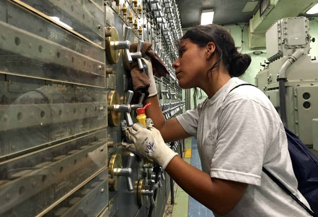 Airman Angie Carbajal, 419th Security Forces Squadron, polishes the brass aboard the USS Missouri during her day off while on annual tour at Joint Base Pearl Harbor, Hawaii, Aug. 13. (U.S. Air Force photo/Bryan Magana)