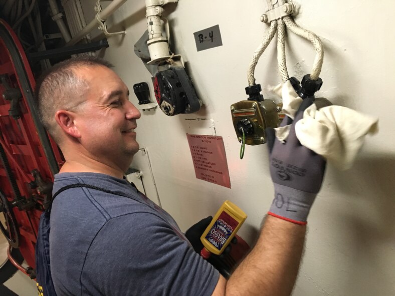 Senior Master Sgt. Timothy Moorehead, 419th Force Support Squadron, polishes the brass aboard the USS Missouri during his day off while on annual tour at Joint Base Pearl Harbor, Hawaii, Aug. 13. (U.S. Air Force photo/Bryan Magana)