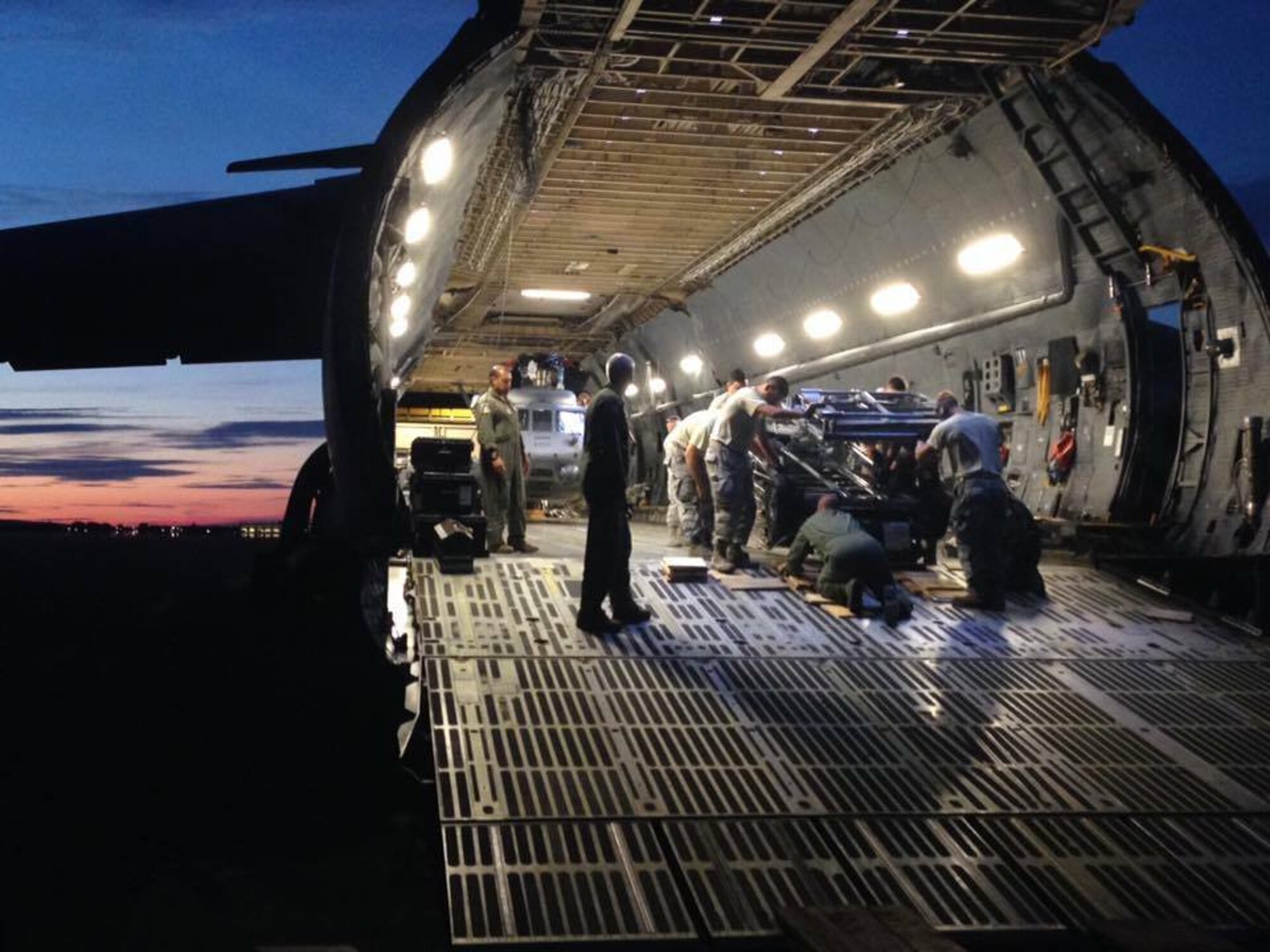 Maintainers and crew chiefs unload a Dover Air Force Base C-5M on the flight line at Plattsburgh International Airport, NY, July 31, 2016. Team Dover flew two HH-60s and Air Force Reserve Rescue personnel from Davis-Monthan Air Force Base for joint training. (Photo by Paul Anderson)
