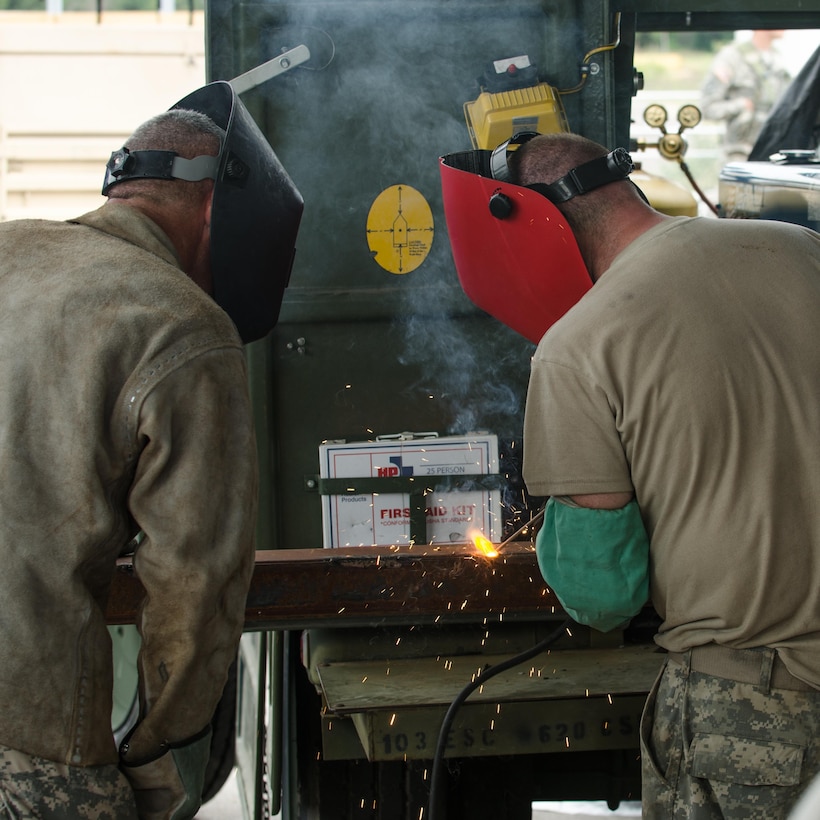 U.S. Army Reserve Sgt. David Burton (left) and Pvt. Justin Shanks (right), from the 245th Engineer Company, St. Charles, Mo., weld together metal pieces to form the support structure of a cantilever upright structure during Combat Support Training Exercise (CSTX) 86-16-03 at Fort McCoy, Wis., August 12, 2016. The 84th Training Command’s third and final Combat Support Training Exercise of the year hosted by the 86th Training Division at Fort McCoy, Wis. is a multi-component and joint endeavor aligned with other reserve component exercises. (U.S. Army photo by Spc. Cody Hein/Released)