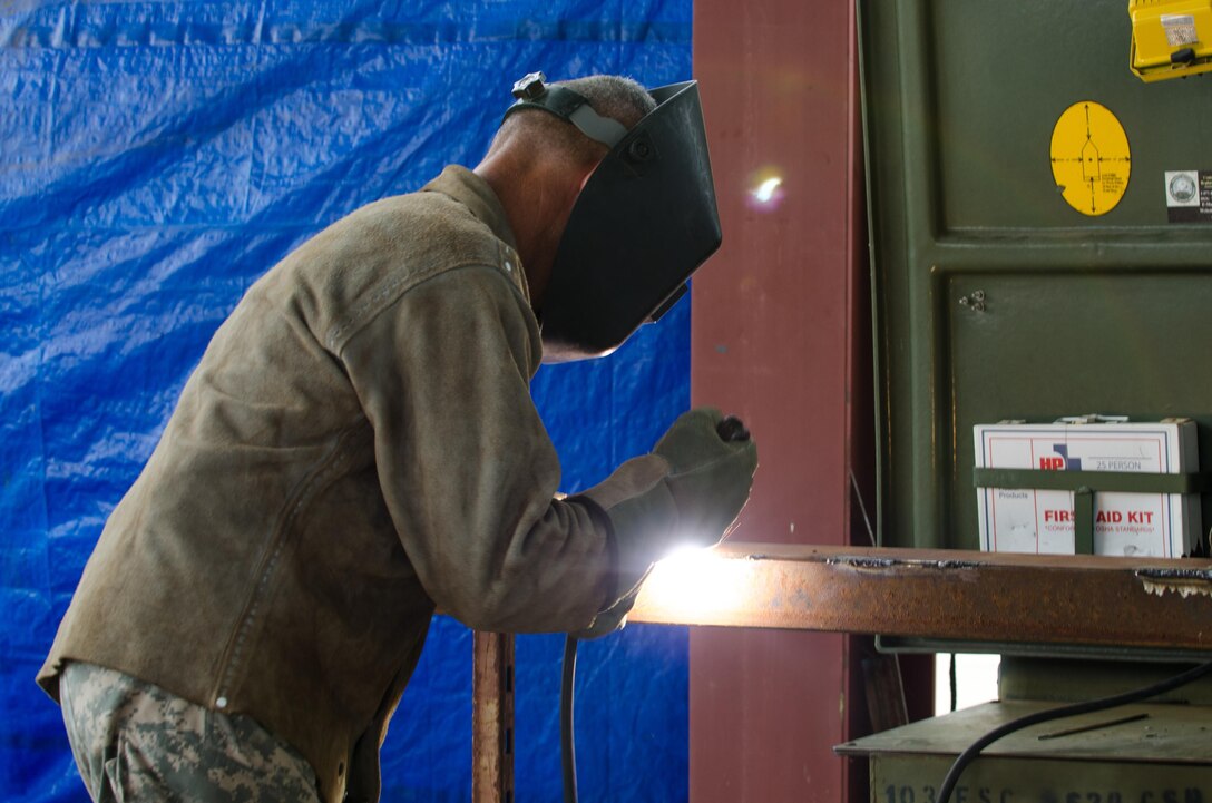 U.S. Army Reserve Sgt. David Burton, from the 245th Engineer Company, St. Charles, Mo., welds together metal pieces to form the support structure of a cantilever upright structure during Combat Support Training Exercise (CSTX) 86-16-03 at Fort McCoy, Wis., August 12, 2016. The 84th Training Command’s third and final Combat Support Training Exercise of the year hosted by the 86th Training Division at Fort McCoy, Wis. is a multi-component and joint endeavor aligned with other reserve component exercises. (U.S. Army photo by Spc. Cody Hein/Released)