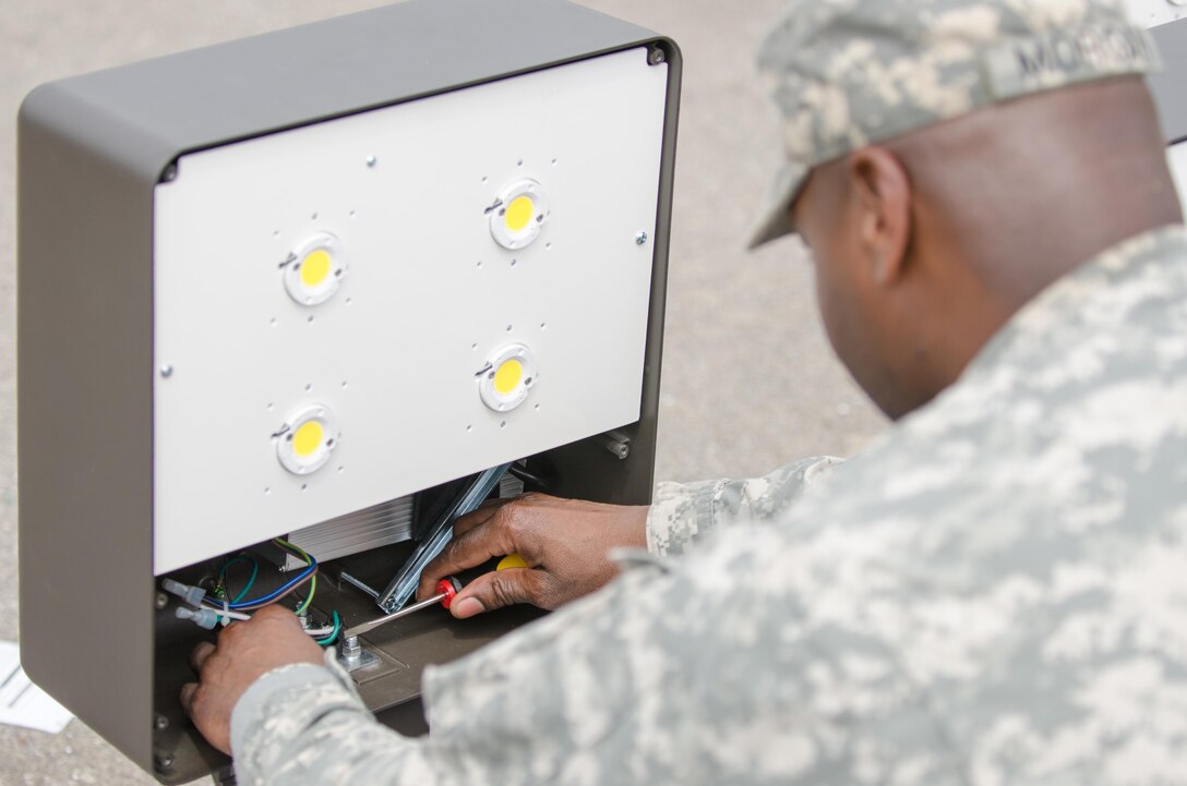 U.S. Army Reserve Sgt. 1st Class Dederrick Morgan, from the 465th Engineer Company, Burmingham, Al., assembles the electrical components for an energy efficient LED street light post during Combat Support Training Exercise (CSTX) 86-16-03 at Fort McCoy, Wis., August 12, 2016. The 84th Training Command’s third and final Combat Support Training Exercise of the year hosted by the 86th Training Division at Fort McCoy, Wis. is a multi-component and joint endeavor aligned with other reserve component exercises. (U.S. Army photo by Spc. Cody Hein/Released)