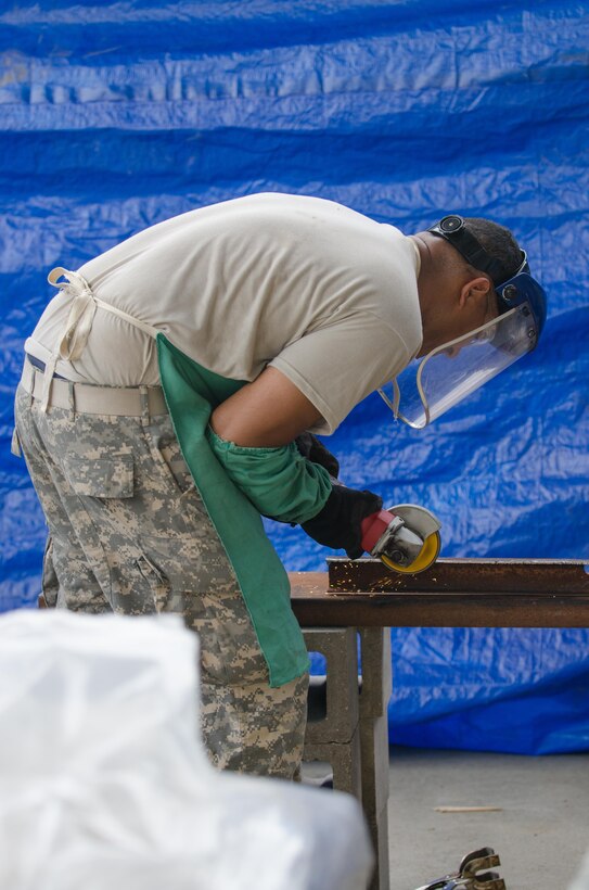 U.S. Army Reserve Spc. Dantoine Ballard, from the 245th Engineer Company, St. Charles, Mo., uses a disc grinder to prepare metal for fabrication during Combat Support Training Exercise (CSTX) 86-16-03 at Fort McCoy, Wis., August 12, 2016. The 84th Training Command’s third and final Combat Support Training Exercise of the year hosted by the 86th Training Division at Fort McCoy, Wis. is a multi-component and joint endeavor aligned with other reserve component exercises. (U.S. Army photo by Spc. Cody Hein/Released)