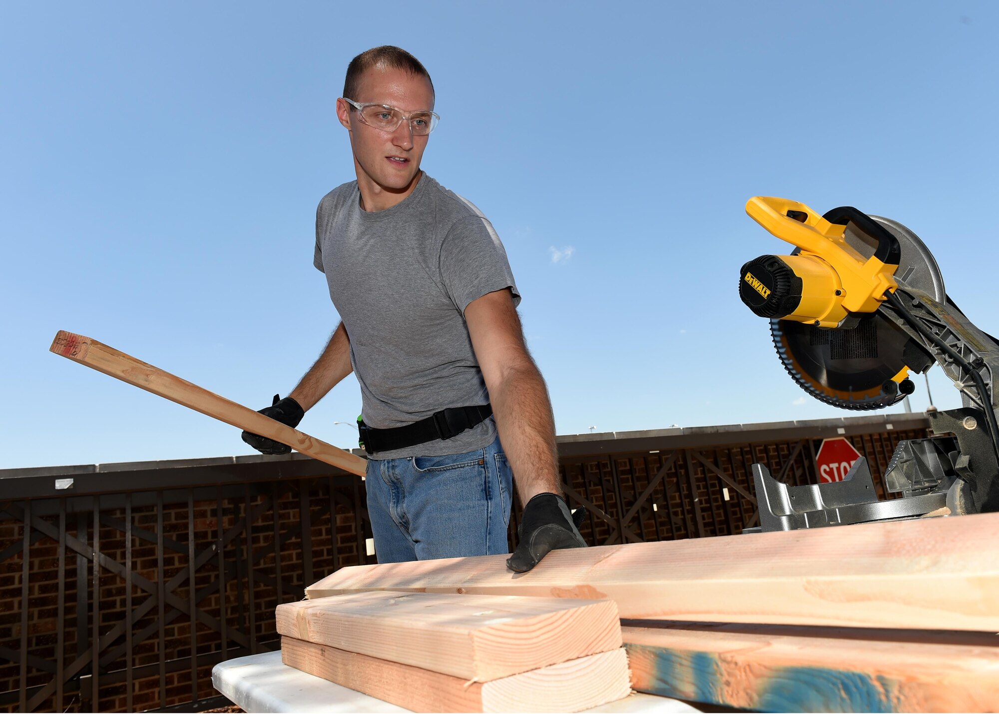 U.S. Air Force Airman 1st Class Jason Martin, 97th Security Forces Squadron response force member, cuts boards August 1, 2016, at Altus Air Force Base Okla. 97th SFS Airmen, led by Martin, took the initiative to remodel the main gate entry facility to improve efficiency and aesthetics. (U.S. Air Force photo by Airman 1st Class Kirby Turbak/Released)