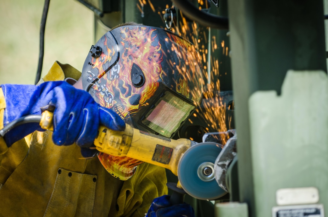 U.S. Army Reserve Spc. Jeremy Loos, from the 652nd Engineer Company, Hammond, Wis., uses a metal grinder on a frame of a Heavy Expanded Mobility Tactical Truck (HEMTT) M1977 while repairing the vehicle during Combat Support Training Exercise (CSTX) 86-16-03 at Fort McCoy, Wis., August 13, 2016. The 84th Training Command’s third and final Combat Support Training Exercise of the year hosted by the 86th Training Division at Fort McCoy, Wis. is a multi-component and joint endeavor aligned with other reserve component exercises. (U.S. Army photo by Spc. Cody Hein/Released)