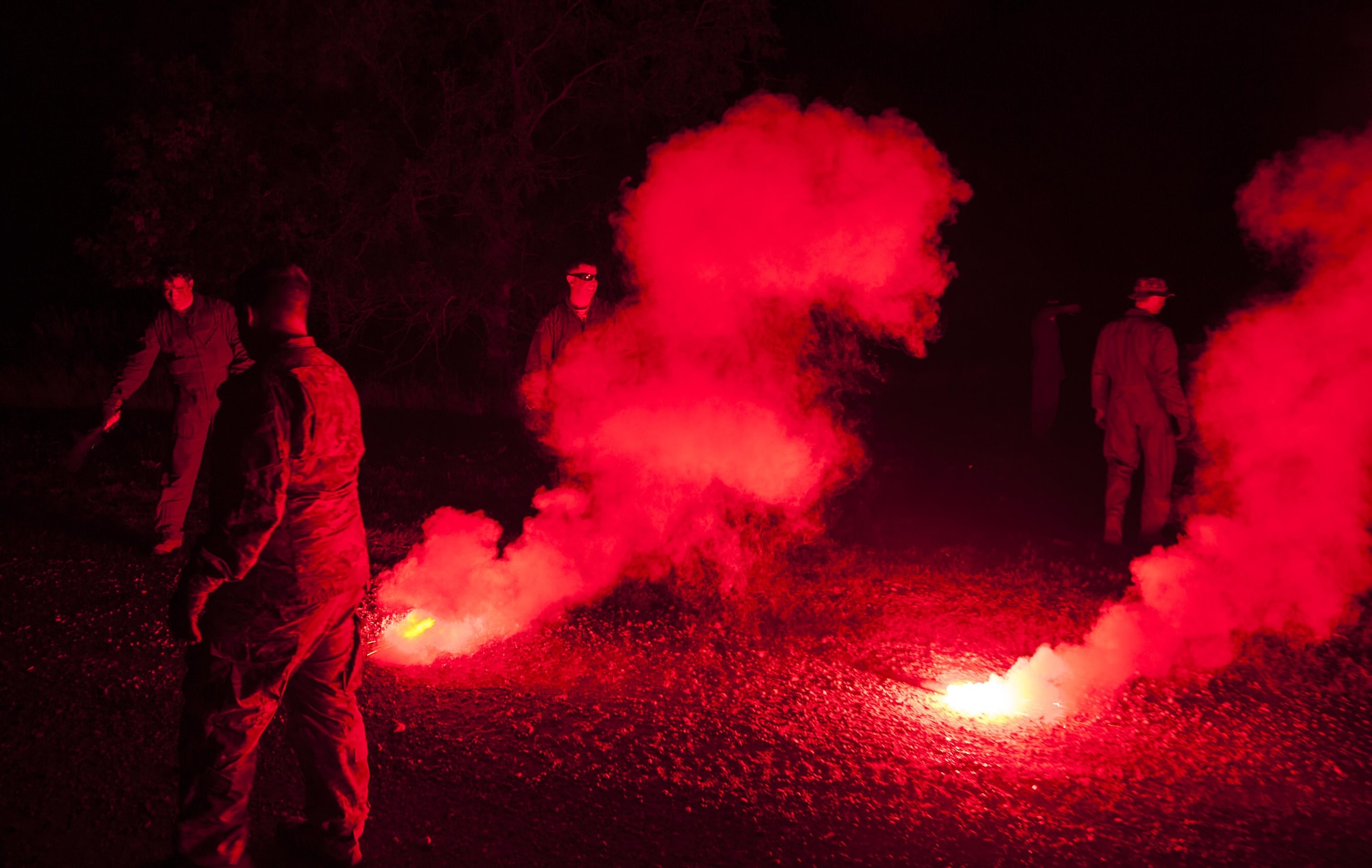 Minot Airmen pop flares with survive, evasion, resistance and escape specialists at a training facility in Garrison, N.D., Aug. 11, 2016. Members practiced setting off the smoke and flares to learn how to signal for help. (U.S. Air Force photo/Airman 1st Class Christian Sullivan)