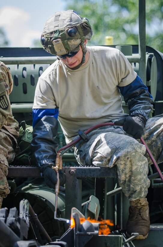 U.S. Army Reserve Pvt. Jade Drews, from the 652nd Engineer Company, Hammond, Wis., uses a blowtorch while repairing a Heavy Expanded Mobility Tactical Truck (HEMTT) M1977 during Combat Support Training Exercise (CSTX) 86-16-03 at Fort McCoy, Wis., August 13, 2016. The 84th Training Command’s third and final Combat Support Training Exercise of the year hosted by the 86th Training Division at Fort McCoy, Wis. is a multi-component and joint endeavor aligned with other reserve component exercises. (U.S. Army photo by Spc. Cody Hein/Released)