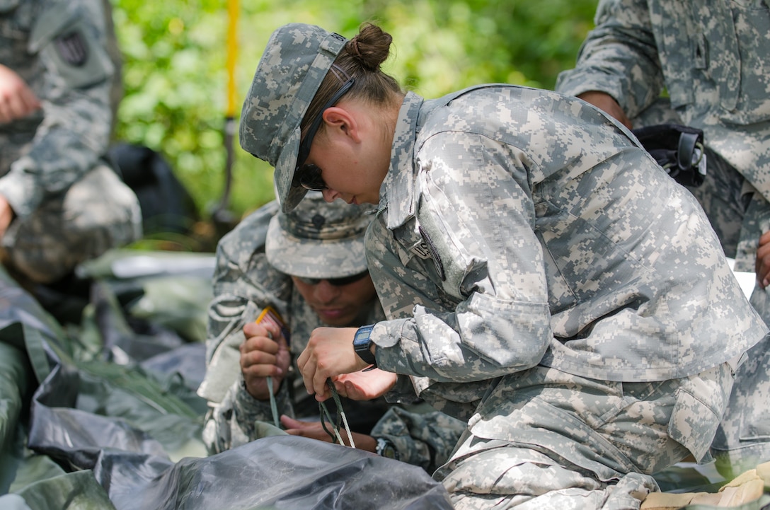 U.S. Army Reserve Spc. Blaire Burke, from the 336th Engineering Firefighting Detachment, Sturtevant, Wis., ties together tent canvas pieces while setting up living quarters in a tactical assembly area during Combat Support Training Exercise (CSTX) 86-16-03 at Fort McCoy, Wis., August 13, 2016. The 84th Training Command’s third and final Combat Support Training Exercise of the year hosted by the 86th Training Division at Fort McCoy, Wis. is a multi-component and joint endeavor aligned with other reserve component exercises. (U.S. Army photo by Spc. Cody Hein/Released)