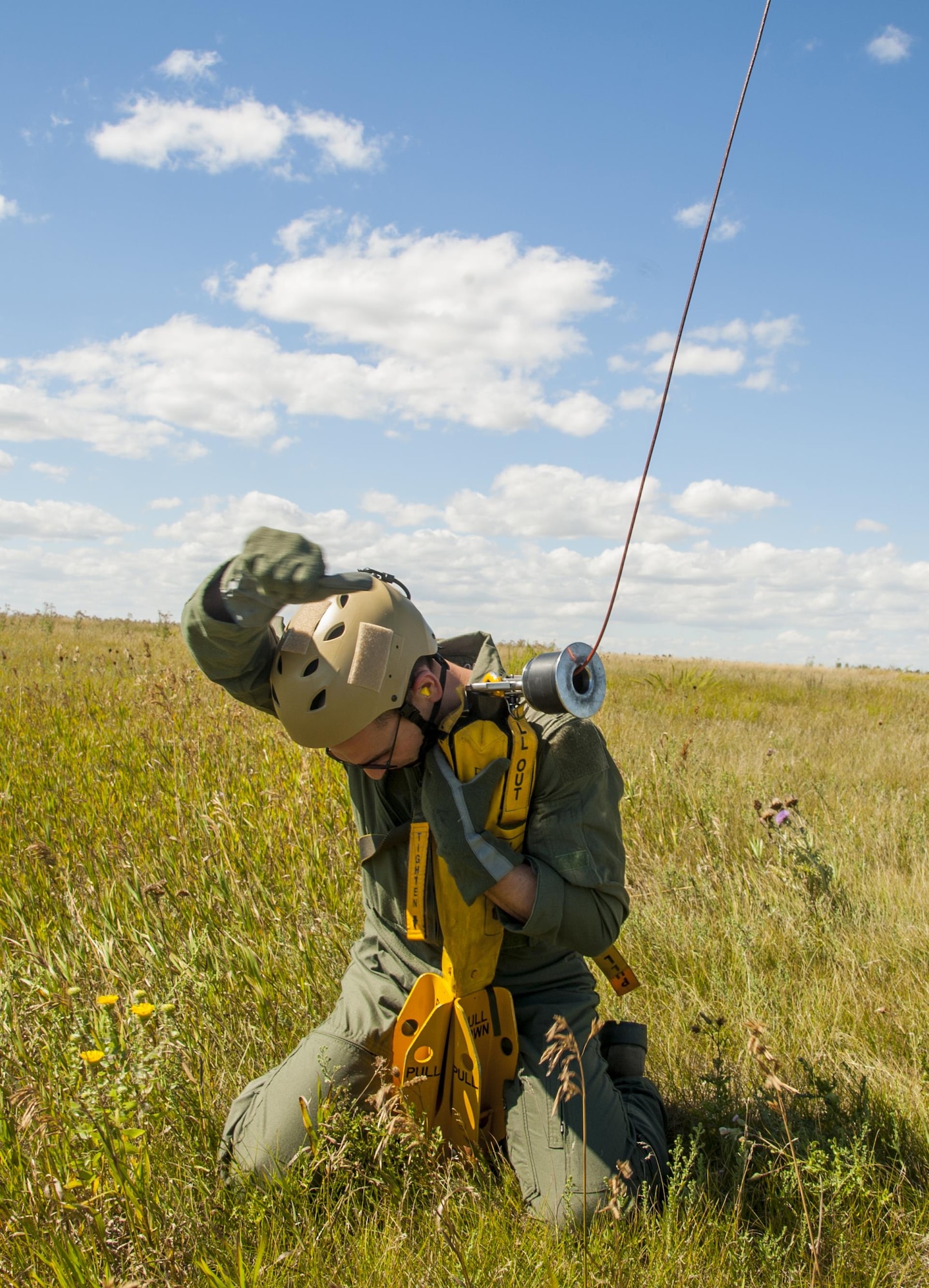 A Minot Airman signals to be hoisted up during a training exercise in Garrison, N.D., Aug. 11, 2016. Members of the 23rd and 69th Bomb Squadrons, along with the 54th Helicopter Squadron trained with survive, evasion, resistance and escape specialists in a recovery exercise. (U.S. Air Force photo/Airman 1st Class Christian Sullivan)