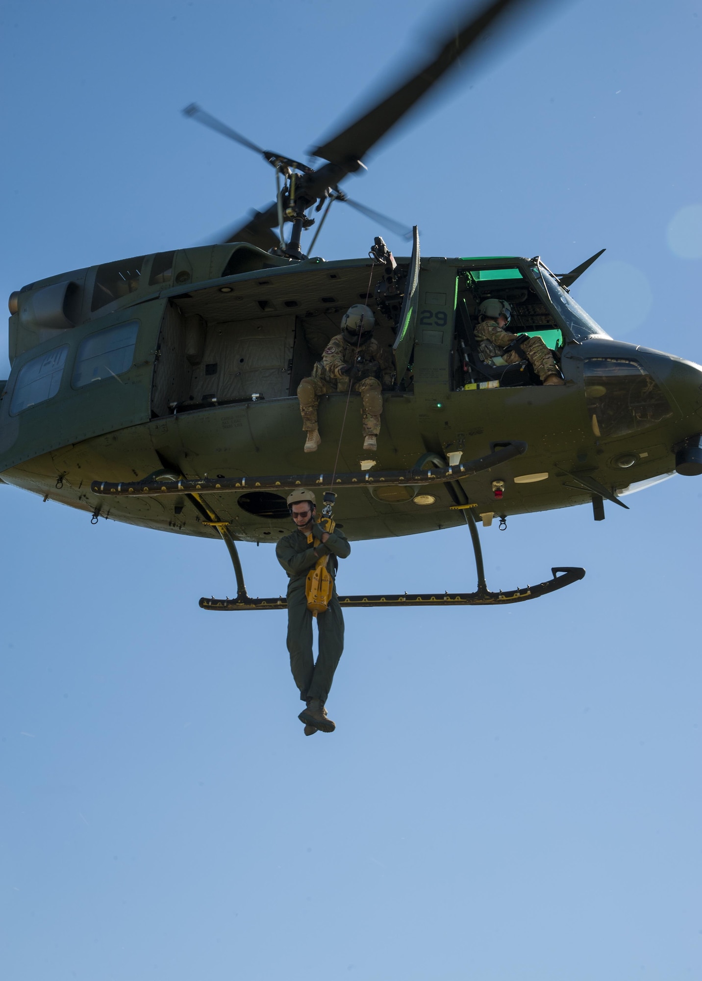 A Minot Airman is hoisted up during a training exercise in Garrison, N.D., Aug. 11, 2016. During the training, several different squadrons paired with survive, evasion, resistance and escape specialist to practice helicopter hoisting, land navigation, evade and recovery and other SERE-based events. (U.S. Air Force photo/Airman 1st Class Christian Sullivan)