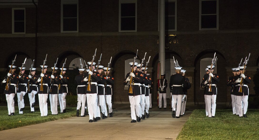 The United States Marine Corps Silent Drill Platoon performs during the Evening Parade at Marine Barracks, Washington, D.C., Aug. 12, 2016. The guests of honor for the parade were Vice Adm. John Aquilino, deputy chief of Naval Operations, Plans and Strategies, Rear Adm. Linda Fagan, deputy commandant for Operations, Policy and Capabilities, Lt. Gen. William Mayville Jr., director of the Joint Staff, Lt. Gen. Joseph Anderson, joint staff deputy Chief of Staff, Lt. Gen John Raymond, deputy chief of Staff and Operations, and Maj. Gen James Witham, director of Domestic Operations and Force Development. The hosting official for the parade was Lt. Gen. Ronald Bailey, deputy commandant for Plans, Policies and Operations. (Official Marine Corps photo by Lance Cpl. Robert Knapp/Released)