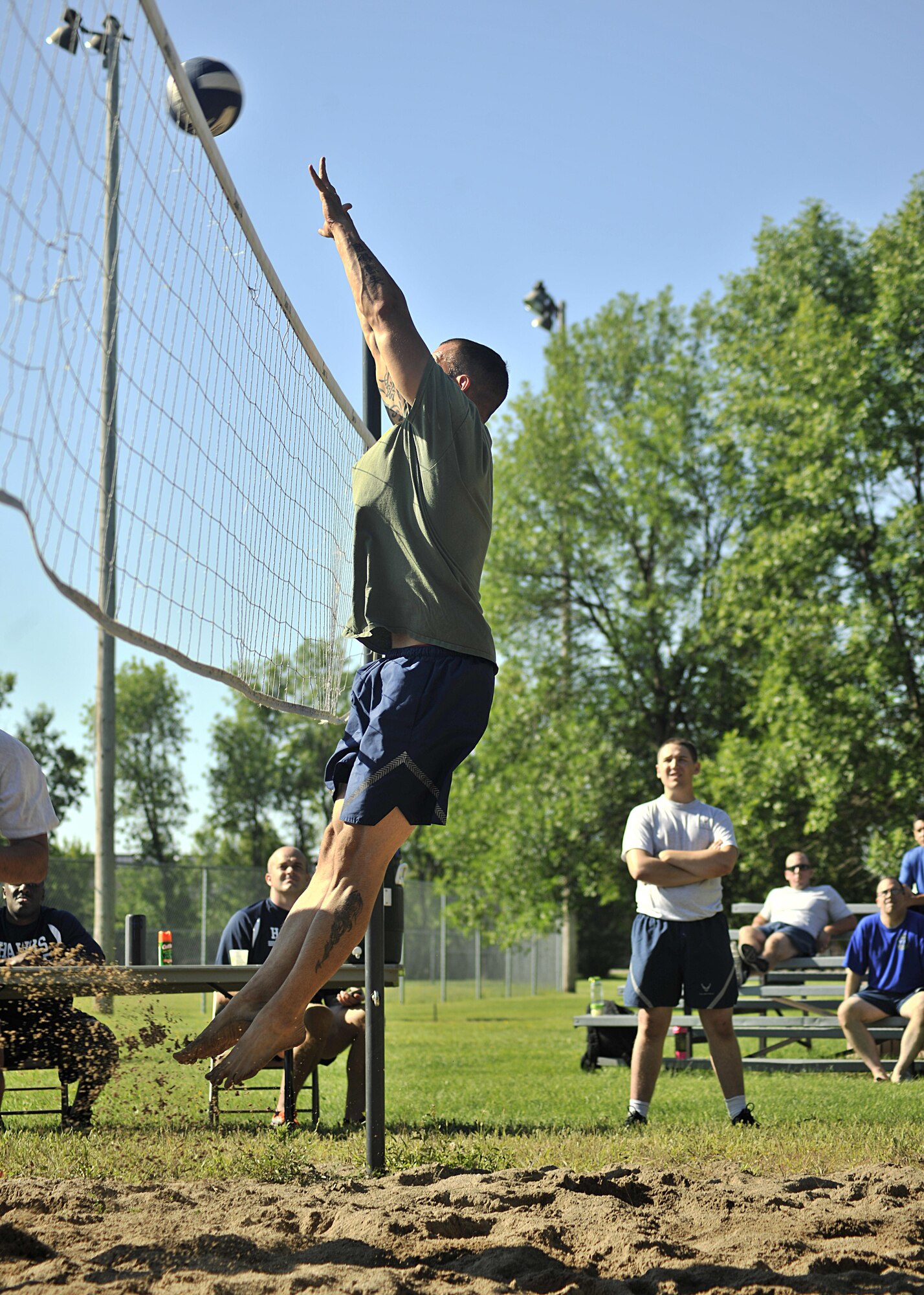 Senior Master Sgt. Brandon Wolfgang, 319th Security Forces Squadron superintendent, jumps to block a during the beach volleyball competition on Aug. 12, 2016, on Grand Forks Air Force Base, N.D. Squadrons from across the base participated in 14 different events during the annual Summer Bash. (U.S. Air Force photo by Senior Airman Xavier Navarro/Released)