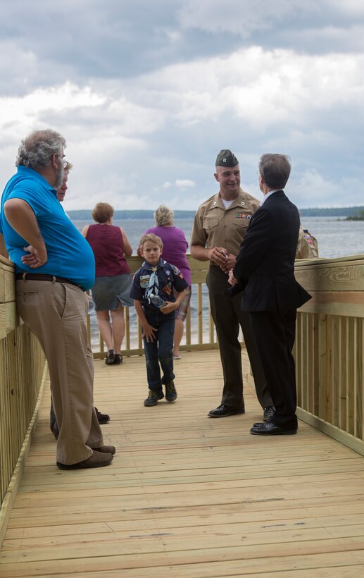 Capt. Brandon Bolhous, the officer in charge with 6th Engineer Support Battalion, 4th Marine Logistics Group, Marine Forces Reserve, gives a tour of the new boardwalk the Marines of 6th ESB completed during their annual Innovative Readiness Training in Standish, Maine, August 12, 2016. The boardwalk now allows access to the newly dedicated John H. Rich Jr. and Doris Lee Rich Memorial Beach and Ice Fishing Access Facility. The Marines were able to utilize their skills to complete both vertical and horizontal construction projects to include a new road way, a parking lot able to hold 100 cars, four vertical structures and a boardwalk to lead to the beach. (U.S. Marine Corps photo by Sgt. Sara Graham) 