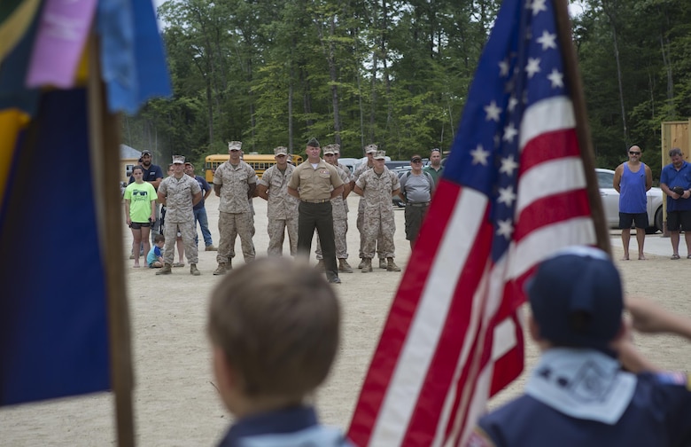 Marines with 6th Engineer Support Battalion, 4th Marine Logistics Group, Marine Forces Reserve, are saluted for their contributions to the community during the John H. Rich Jr. and Doris Lee Rich Memorial Beach and Ice Fishing Access Facility Dedication Ceremony in Standish, Maine, August 12, 2016. The Marines helped make the beach more accessible to the community during their annual Innovative Readiness Training exercise. (U.S. Marine Corps photo by Sgt. Sara Graham) 