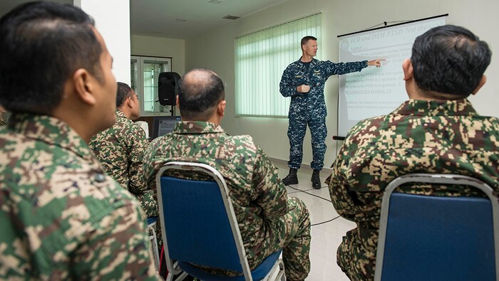 Lt. Cmdr. Justin Campbell, from Thomasville, Alabama, a research psychologist assigned to hospital ship USNS Mercy (T-AH 19),  addresses participants of a Pacific Partnership 2016 operational medicine symposium, Aug 11, 2016.   During the symposium, Malaysian Army service members and Pacific Partnership 2016 personnel discussed mental health issues related to combat deployment, cardiology topics relative to operational platforms within diving, and Malaysian Armed Forces experiences with rapid medical response. This is the first time Mercy and Pacific Partnership have visited Malaysia. During the mission stop partner nations are working side-by-side with local military and civilian organizations in a search and rescue exercise, civil engineering projects, community relation events and subject matter expert exchanges. 