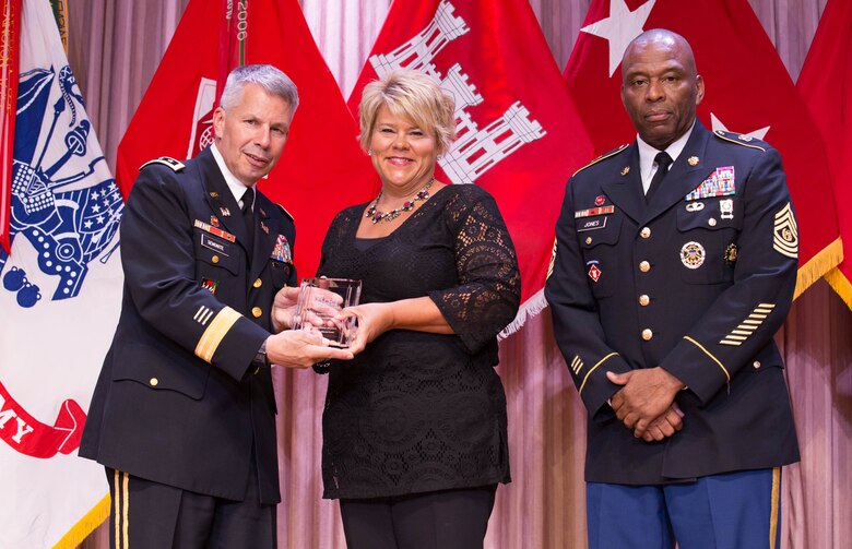 Kris Fairbanks, center, receives the Family Readiness Outstanding Team Achievement Award from Lt. Gen. Todd T. Semonite, Chief of Engineers and U.S. Army Corps of Engineers commanding general and Command Sgt. Maj. Antonio S. Jones during the 2016 National Awards Ceremony  in Washington, D.C., Aug. 4 Fairbanks accepted the award on behalf of the Mississippi Valley Division team. She also was the 2015 Family Readiness Individual Excellence Award recipient. 
