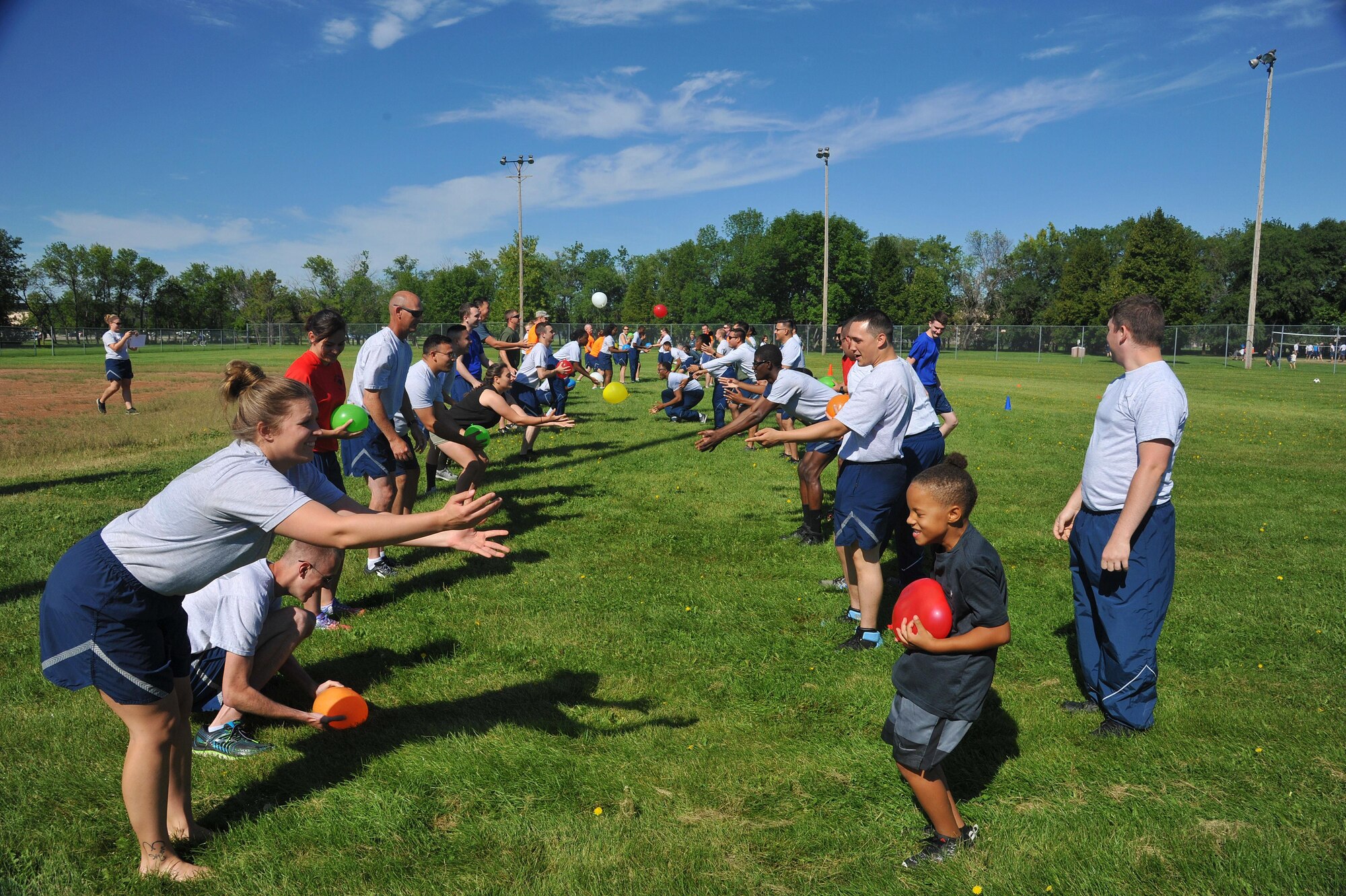 Airmen and family members compete in a classic water balloon toss competition during the 2016 Summer Bash, August 12 on Grand Forks Air Force Base, N.D. Teams of two toss water balloons back and forth while increasing the distance between themselves.  (U.S. Air Force Photo by Airman 1st Class Elijaih Tiggs/released)