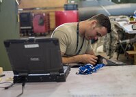 U.S. Air Force Staff Sgt. John Dunlap, a 35th Aircraft Maintenance Unit F-16 Fighting Falcon crew chief deployed from Kunsan Air Base, Republic of Korea, repairs and engine cover Aug. 11, 2016, during RED FLAG-Alaska (RF-A) 16-3 at Eielson Air Force Base, Alaska. Dunlap is in charge of issuing and ensuring the continuity of equipment and materials for 155 Airmen during RF-A, which provides unique opportunities to integrate various forces into joint, coalition and multilateral training from simulated forward operating bases. (U.S. Air Force photo by Staff Sgt. Shawn Nickel)