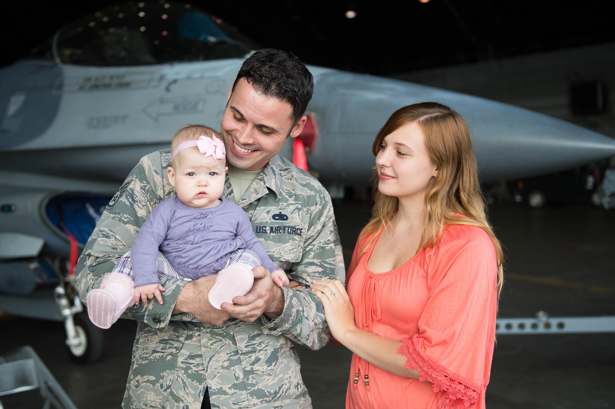 U.S Air Force Staff Sgt. John Dunlap, a 35th Aircraft Maintenance Unit F-16 Fighting Falcon crew chief deployed from Kunsan Air Base, Republic of Korea, his wife Jennifer and 6-month-old baby Evelyn, tour the Thunderdome while visiting after his shift Aug. 11, 2016, during RED FLAG-Alaska 16-3, at Eielson Air Force Base, Alaska. Jennifer and the baby met Dunlap in Alaska to visit for the first time in the U.S. while he has been stationed at Kunsan, a remote duty location, where families are not permitted to reside with their sponsors. (U.S. Air Force photo by Staff Sgt. Shawn Nickel)