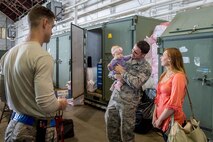 U.S. Air Force Staff Sgt. John Dunlap, a 35th Aircraft Maintenance Unit F-16 Fighting Falcon crew chief deployed from Kunsan Air Base, Republic of Korea, introduces his wife Jennifer and 6-month-old baby Evelyn, to coworkers at the Thunderdome after his shift Aug. 11, 2016, during RED FLAG-Alaska (RF-A) 16-3 at Eielson Air Force Base, Alaska. RF-A, a Pacific Air Forces commander-directed exercise, gave the family a cost effective opportunity to visit within the U.S. during Dunlap’s off time. (U.S. Air Force photo by Staff Sgt. Shawn Nickel)