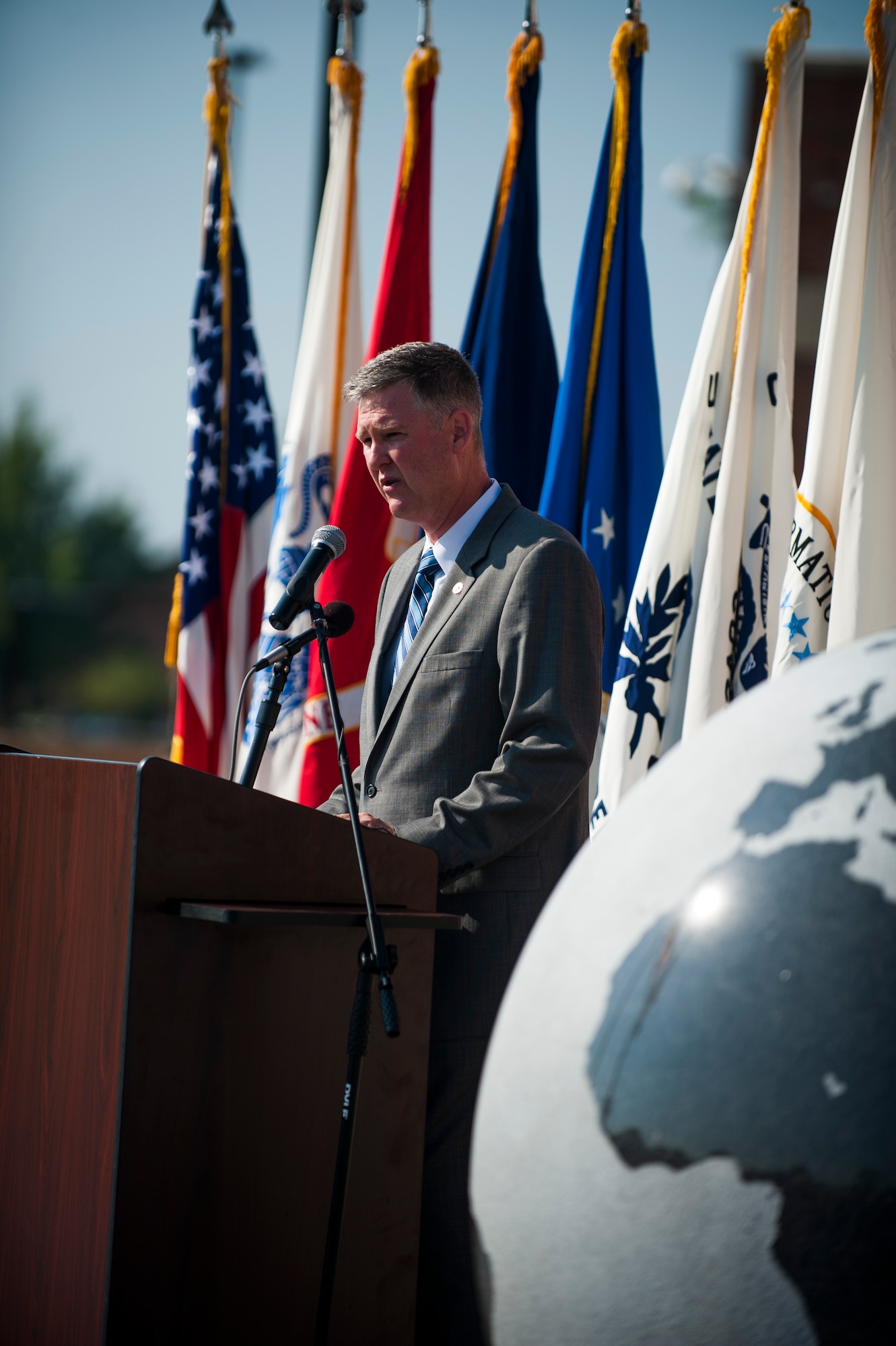 Dana Rowe, Defense Information Systems Agency Global Operations Command deputy commander, introduces distinguished visitors during the ribbon cutting ceremony for the new DISA compound at Scott Air Force Base, Ill., Aug. 11, 2016. The $100 million facility was completed on time and under budget. (U.S. Air Force photo by Staff Sgt. Clayton Lenhardt/Released)