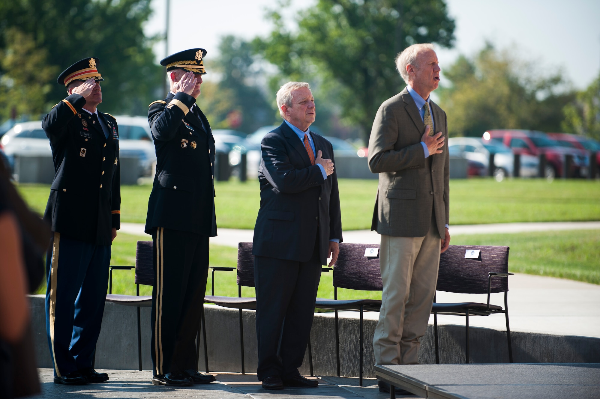 U.S. Army Col. Paul Craft, Defense Information Systems Agency Global Operations Command commander, Lt. Gen. Alan Lynn, DISA director, Sen. Dick Durbin and Ill. Gov. Bruce Rauner observe the national anthem during a ribbon cutting ceremony for the new DISA compound at Scott Air Force Base, Ill., Aug. 11, 2016. Civil leaders from across the state attended the opening of the state of the art compound. (U.S. Air Force photo by Staff Sgt. Clayton Lenhardt/Released)