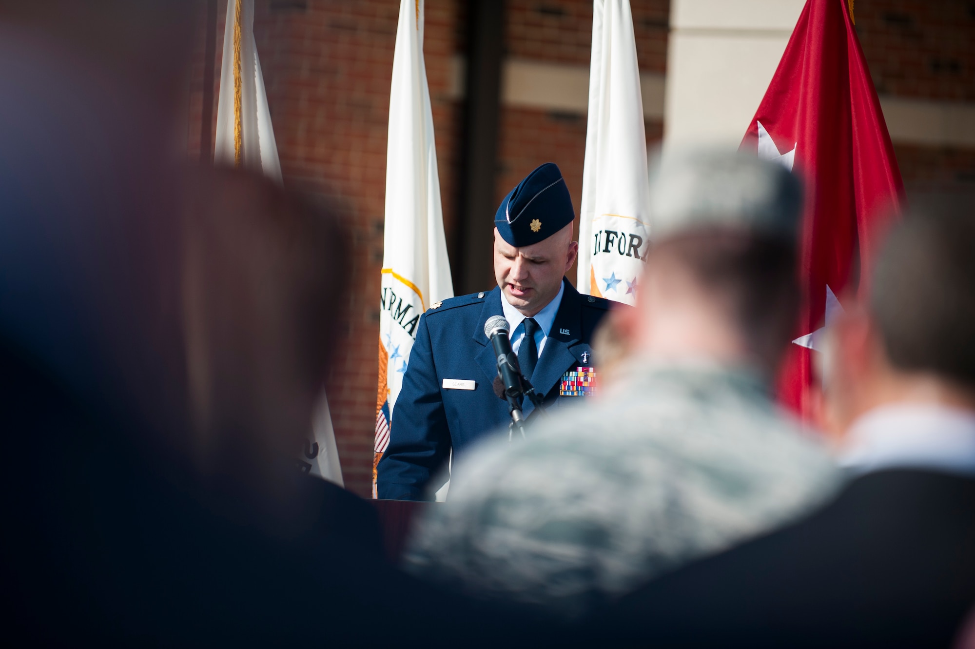 Maj. Travis Sears, 375th Air Mobility Wing chaplain, delivers an invocation during a ribbon cutting ceremony for the new Defense Information Systems Agency compound at Scott Air Force Base, Ill., Aug. 11, 2016. The 164,000 sq. ft. complex includes a wellness center with fitness equipment and locker space available to DISA employees 24 hours a day. (U.S. Air Force photo by Staff Sgt. Clayton Lenhardt/Released)
