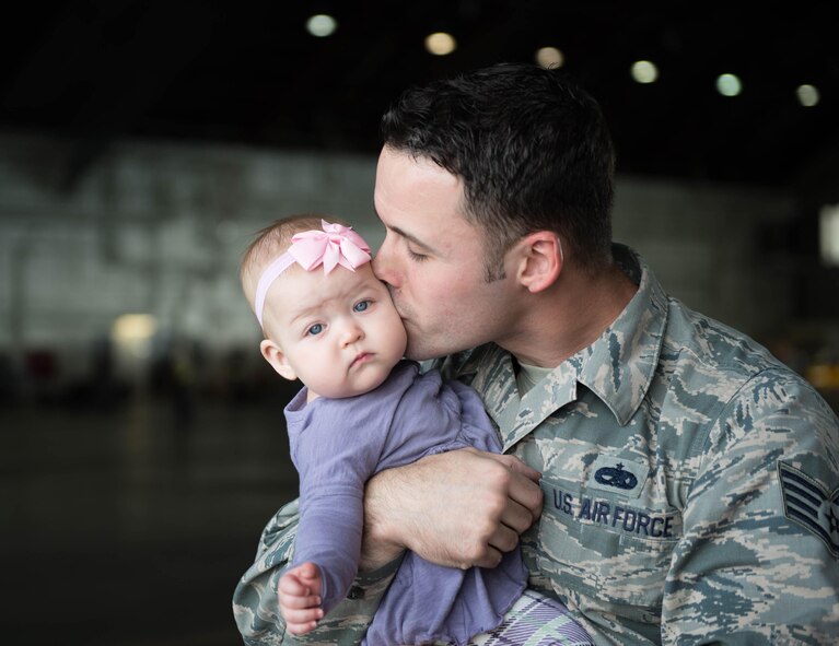 U.S. Air Force Staff Sgt. John Dunlap, a 35th Aircraft Maintenance Unit F-16 Fighting Falcon crew chief deployed from Kunsan Air Base, Republic of Korea, kisses his 6-month-old baby Evelyn after his shift Aug. 11, 2016, during RED FLAG-Alaska (RF-A) 16-3 at Eielson Air Force Base, Alaska. Dunlap’s family took the time he was in the U.S. to visit during RF-A, a Pacific Air Forces commander-directed exercise, which is vital to maintaining peace and stability in the Indo-Asia-Pacific area of responsibility. (U.S. Air Force photo by Staff Sgt. Shawn Nickel)