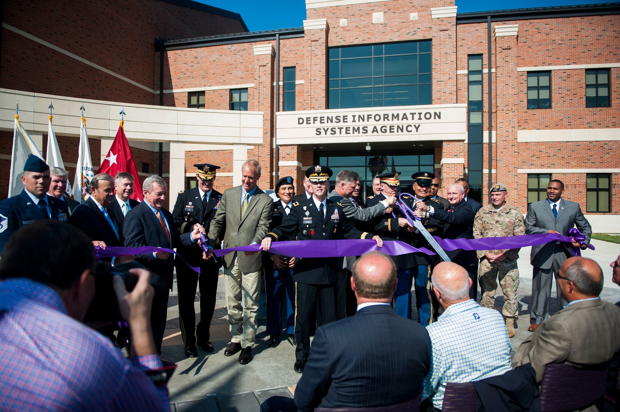 Military and state leaders cut the ribbon officially opening the new Defense Information Systems Agency compound at Scott Air Force Base, Ill., Aug. 11, 2016. The $100 million facility was completed on time and under budget. (U.S. Air Force photo by Staff Sgt. Clayton Lenhardt/Released)