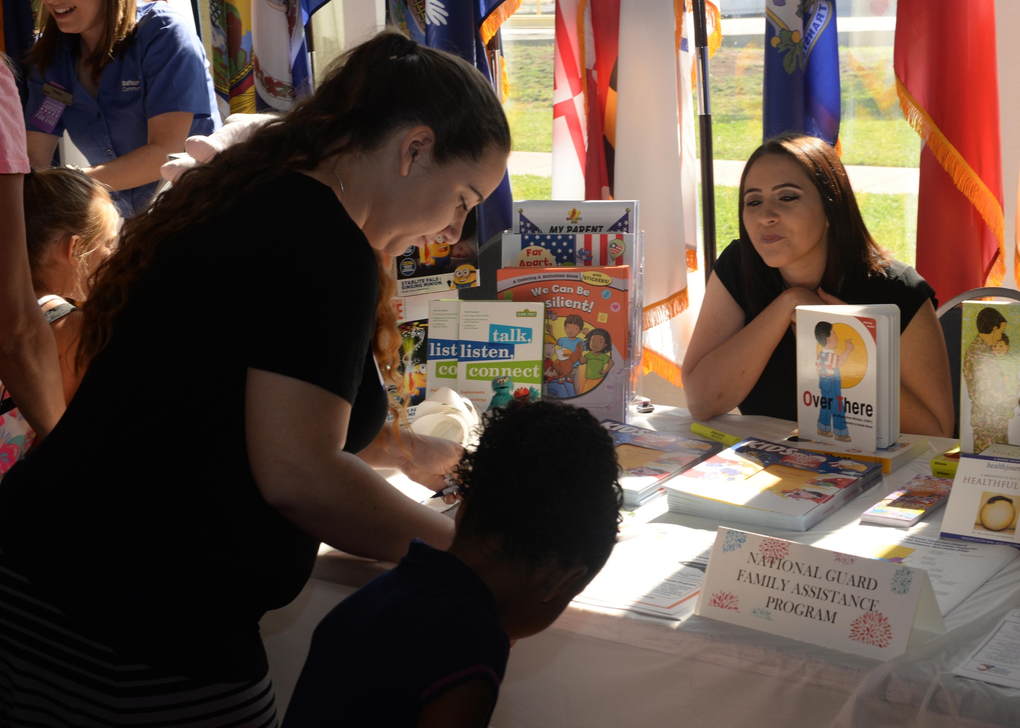 A participant at Beale’s Baby Shower reads information offered from the National Guard Family Assistance Program Aug. 13, 2016, at Beale Air Force Base, California. The event provided Team Beale’s new and expecting families the opportunity to build relationships with others, participate in baby shower activities and get information from approximately 40 agencies on and off base. The agencies provided services and information such as nutrition assistance, healthy living information, child development and parental education. (U.S. Air Force photo by Airman Tristan D. Viglianco)