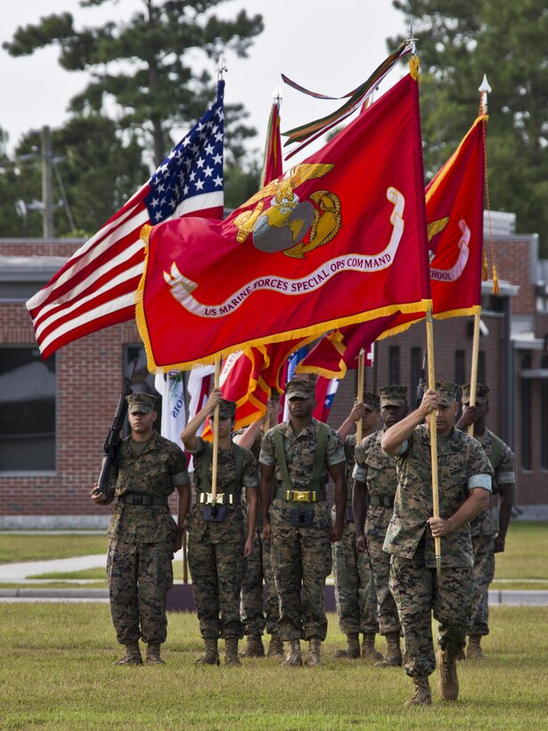 U.S. Marine Corps Sgt. Maj. Douglas B. Schaefer, command sergeant major of Marine Corps Special Operations Command (MARSOC), marches the National Ensign across the parade field for the MARSOC Change of Command on Stone Bay, Camp Lejeune, N.C., July 26, 2016. 33rd Assistant Commandant of the Marine Corps, Gen. John M. Paxton Jr., was the guest speaker for the event. (U.S. Marine Corps photo by Lance Cpl. Hailey D. Stuart)