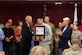 Air Force Maj. William Howarth (center) accepts the U.S. Army Medicine’s 3rd Quarter Wolf Pack award from Gregg Stevens on behalf of the Total Joint Replacement Program team. (Photo by Jeff Troth)