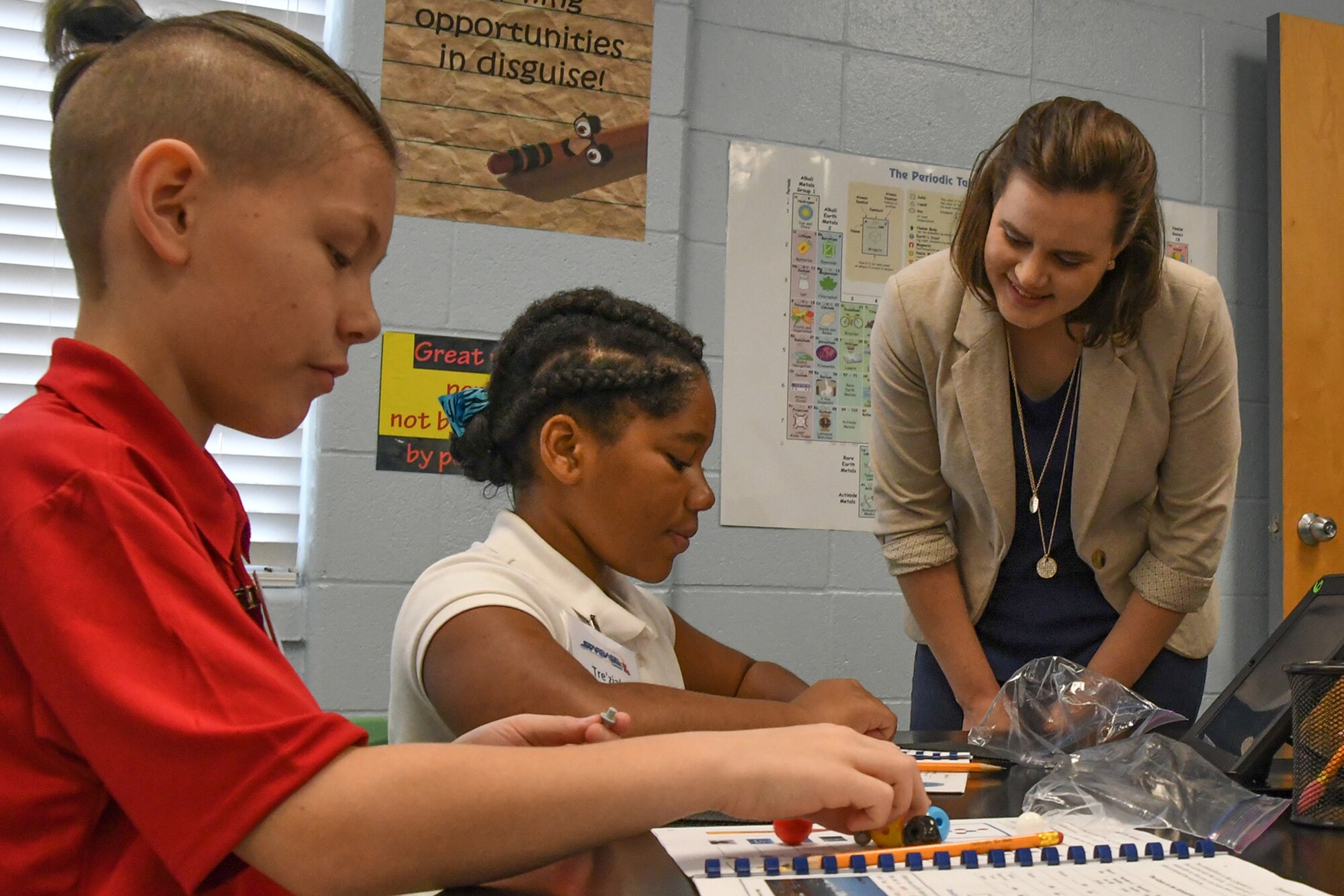 Local 5th grade students show Kathryn Doherty, the military liaison and legislative director for Congressman John Fleming, the difference between an element and a compound at STARBASE on Barksdale Air Force Base, La., August 10, 2016. Doherty toured the 307th Bomb Wing sponsored STARBASE to show the impact the organization has in encouraging STEM (Science, Technology, Engineering and Math) learning to all local area 5th graders. (U.S. Air Force photo by Master Sgt. Dachelle Melville/Released)