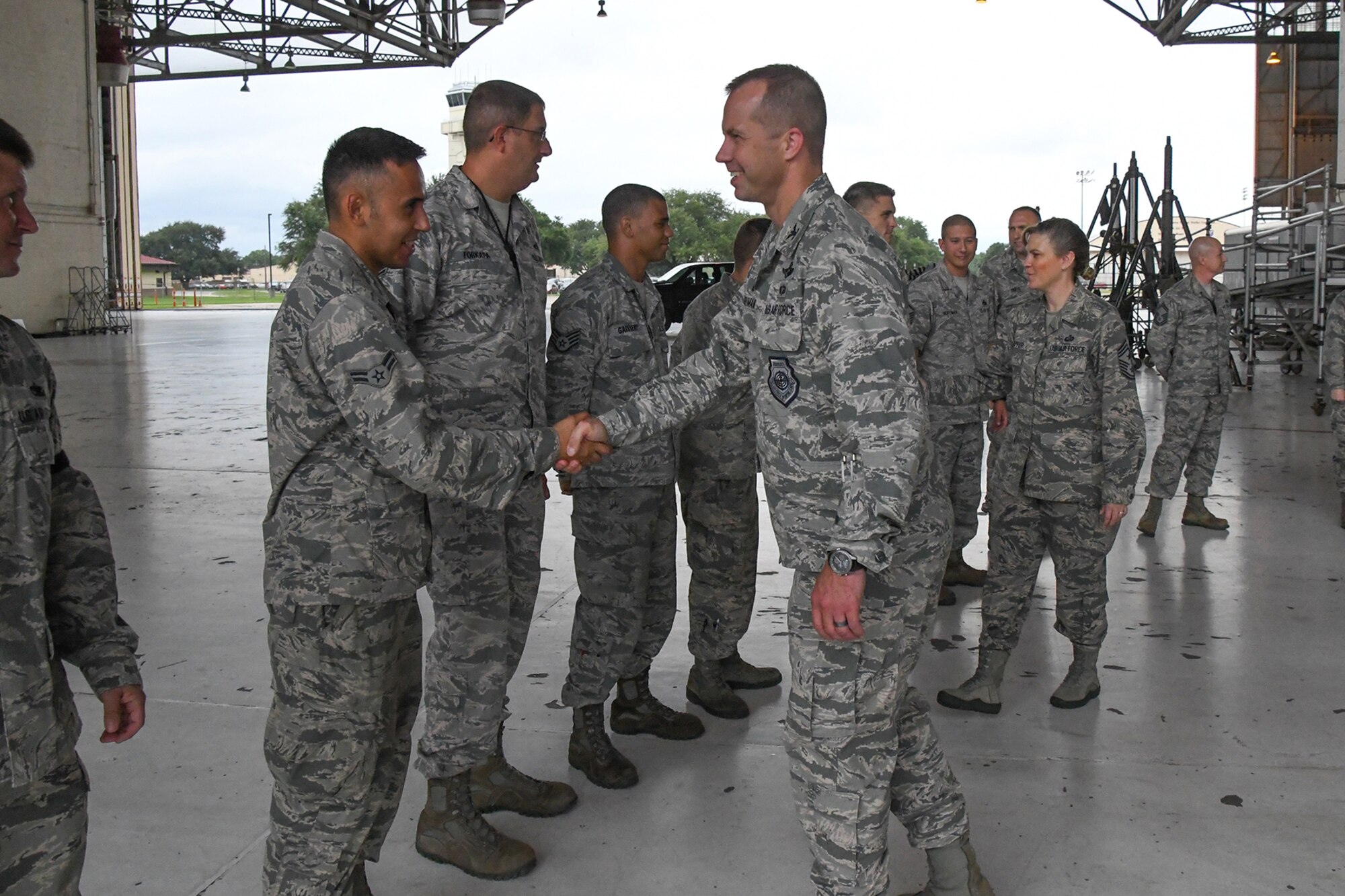U.S. Air Force Col. Ty Neuman, the 2nd Bomb Wing commander, and Chief Master Sgt. Teresa Clapper, the Command Chief for the 2 BW, shake hands with Active Duty and Reserve Airmen assigned to the 307th Aircraft Maintenance Squadron on August 15, 2016. Neuman is the new base commander for Barksdale Air Force Base in Louisiana and is receiving a tour of the 307th Bomb Wing which is a tenant unit on the base. (U.S. Air Force photo by Master Sgt. Dachelle Melville/Released)