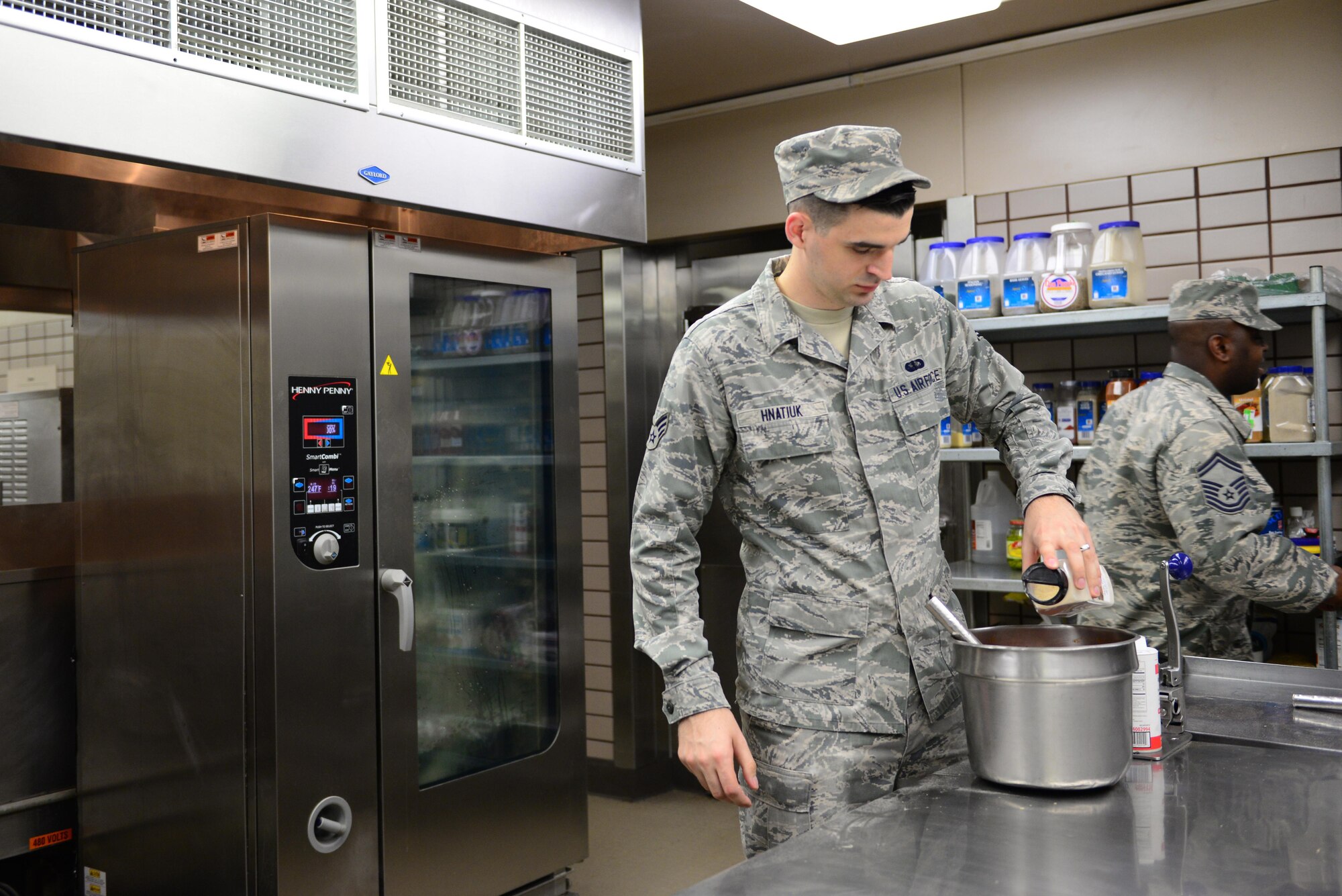 U.S. Air Force Senior Airman Jeremy Hnatiuk, a 354th Force Support Squadron shift leader, prepares food Aug 12, 2016,  during RED FLAG-Alaska (RF-A) 16-3, at Eielson Air Force Base, Alaska. RF-A provides training for deployed maintenance and support personnel in sustainment of large-force deployed air operations. (U.S. Air Force photo by Airman 1st Class Cassandra Whitman)