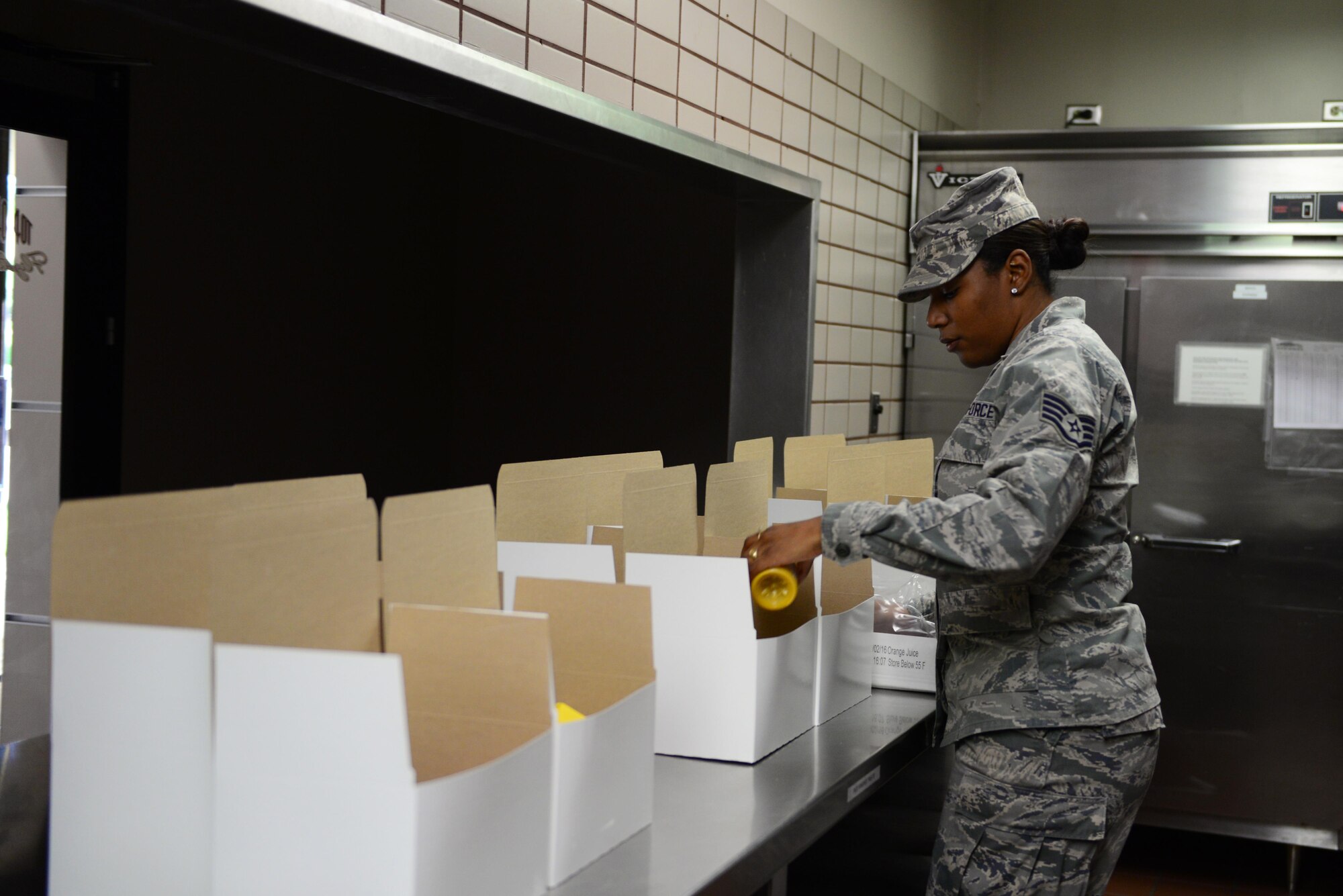 U.S. Air Force Staff Sgt. Theda Shaw, the noncommissioned officer in charge of the 35th Force Support Squadron First Term Airmen’s Center out of Misawa Air Base, Japan, puts juice in flight meal boxes Aug. 12, 2016, during RED FLAG, Alaska (RF-A) 16-3, at Eielson Air Force Base, Alaska. Shaw is temporarily deployed to Eielson in support of RF-A to assist the Two Seasons Dining Facility staff to ensure their mission is met. (U.S. Air Fore photo by Airman 1st Class Cassandra Whitman)