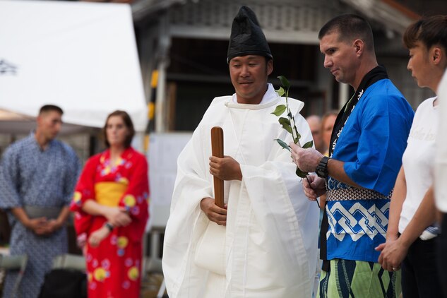 U.S. Marine Corps Chief Warrant Officer Marcus Major, chemical biological radiological nuclear defense officer for Marine Aircraft Group 12, prepares to honor the Shiroyama Hime Shrine during the Bon-Odori Yukata-Experience festival in the Yokoyama area of Iwakuni, Japan, Aug. 13, 2016. Major was invited by the locals to join the honoring of the Shiroyama Hime shrine and said it was an honor to have been part of the ceremony. (U.S. Marine Corps photo by Lance Cpl. Joseph Abrego)