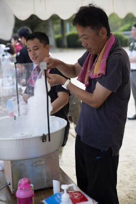 A Japanese local prepares cotton candy for guests attending the Bon-Odori Yukata-Experience festival in the Yokoyama area of Iwakuni, Japan, Aug. 13, 2016. The festival consisted of refreshments, snacks, dancing and honoring those who passed. (U.S. Marine Corps photo by Lance Cpl. Joseph Abrego)
