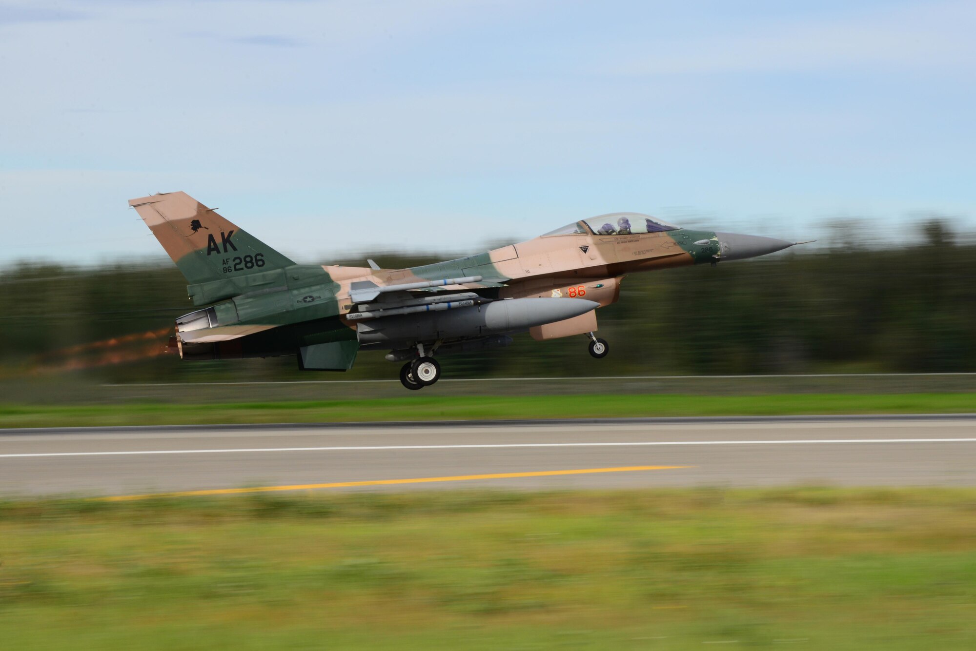 A U.S. Air Force F-16 Fighting Flacon aircraft assigned to the 18th Aggressor Squadron (AGRS) takes off from the Eielson Air Force Base, Alaska, flight line Aug. 15, 2016, during RED FLAG-Alaska (RF-A) 16-3. The 18th AGRS supports RF-A by sharing its knowledge of flying to participating units in the exercise, which ensures the U.S. and its allies receive the best air combat training possible. (U.S. Air Force photo by Airman 1st Class Cassandra Whitman)