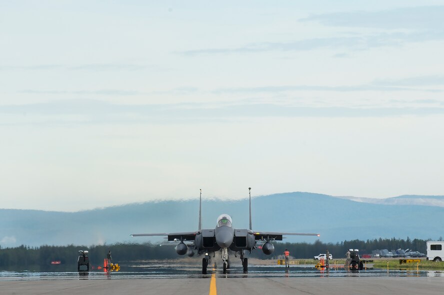 A U.S. Air Force F-15E Strike Eagle dual-role fighter aircraft assigned to the 336th Fighter Squadron from Seymour Johnson Air Force Base, N.C., taxis to the equipment test cell prior to a sortie at Eielson Air Force Base, Alaska, Aug. 15, 2016, during RED FLAG-Alaska (RF-A) 16-3. Free exchange of ideas between multilateral forces during RF-A enhances not just partners and sister-service relationships, but also their operational efficiency. (U.S. Air Force photo by Staff Sgt. Shawn Nickel)