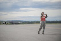 U.S. Air Force Airman 1st Class Nicholas Proia, an avionics technician assigned to the 4th Aircraft Maintenance Squadron from Seymour Johnson Air Force Base, N.C., marshals fighter jets through the test cell to ensure weapons and electronic warfare equipment operate properly prior to a sortie at Eielson Air Force Base, Alaska, Aug. 15, 2016, during RED FLAG-Alaska (RF-A) 16-3. RF-A provides realistic combat training essential to the success of air and space operations while providing unique opportunities to integrate various forces into joint, coalition and multilateral training from simulated forward operating bases. (U.S. Air Force photo by Staff Sgt. Shawn Nickel)