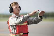 U.S. Air Force Airman 1st Class Nicholas Proia, an avionics technician assigned to the 4th Aircraft Maintenance Squadron from Seymour Johnson Air Force Base, N.C., marshals a U.S. Air Force F-15E Strike Eagle dual-role fighter aircraft into the test cell to ensure weapons and electronic warfare equipment work properly prior to a sortie at Eielson Air Force Base, Alaska, Aug. 15, 2016, during RED FLAG-Alaska (RF-A) 16-3. RF-A enables joint and international maintenance units to sharpen their skills by preparing jets to fly simulated combat sorties in a realistic threat environment. (U.S. Air Force photo by Staff Sgt. Shawn Nickel)