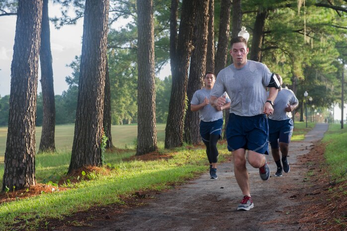 Staff Sgt. Gabriel Lazurka, 628th Comptroller Squadron non-commissioned officer in charge of financial services, leads the way for the rest of his squadron as they run the back gate on Joint Base Charleston – Air Base, S.C., Aug. 5, 2016. Besides running, the 628th CPTS do exercises from yoga and spin class, to cross fit and  a variety of other types of physical training during their workout sessions. (U.S. Air Force photo by Airman 1st Class Thomas T. Charlton)