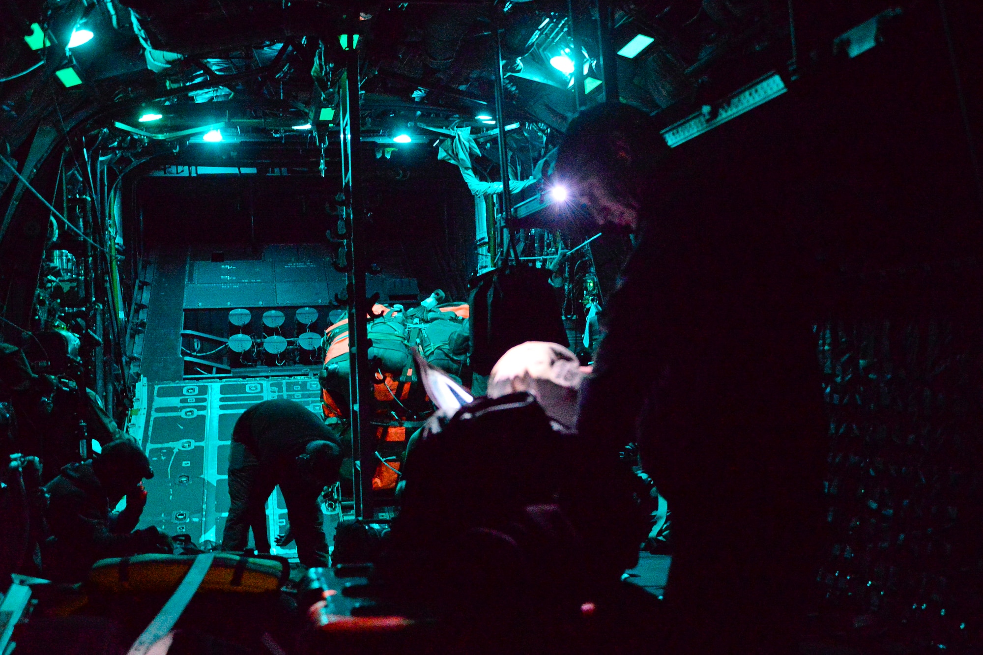 Pararescuemen with the 129th Rescue Wing, prepare their gear and equipment on board an MC130P Combat Shadow aircraft, August 12, 2016. California Air National Guardsmen from the 129th Rescue Wing conducts an overwater rescue mission on the Pacific Ocean in response to a seriously ill 37-year-old crewman on board the HMCS Calgary, a Canadian naval frigate, 800 miles off shore from San Francisco. (U.S. Air National Guard photo by Master Sgt. Ray Aquino/released)