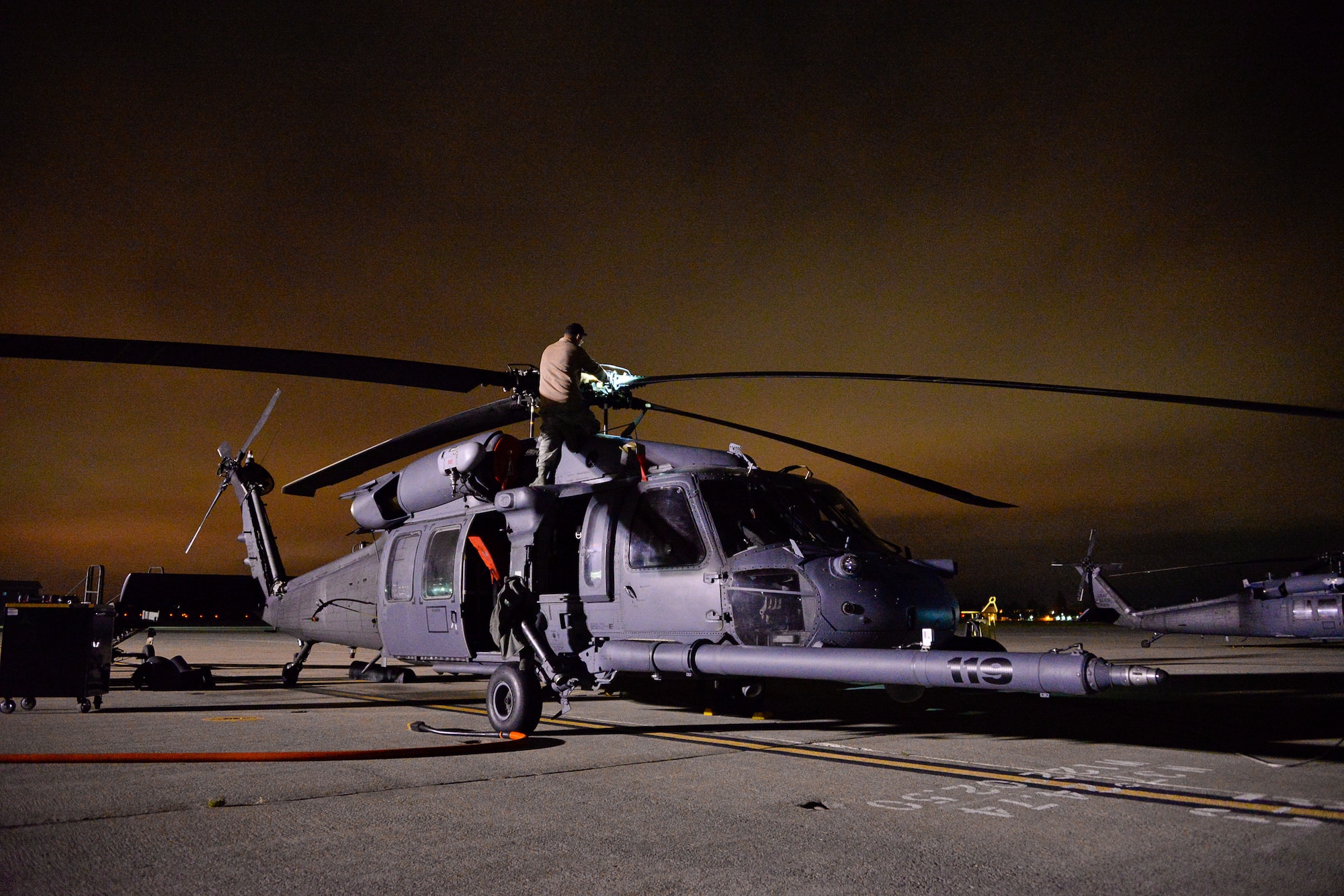 California Air National Guardsmen from the 129th Rescue Wing, Moffett Federal Airfield, Calif., prepares an HH60G Pave Hawk helicopter for a night-time overwater operation, August 12, 2016.  The Guardsmen are preparing for an overwater rescue mission on the Pacific Ocean in response to a seriously ill 37-year-old crewman on board the HMCS Calgary, a Canadian naval frigate, 800 miles off shore from San Francisco. (U.S. Air National Guard photo by Master Sgt. Ray Aquino/released)