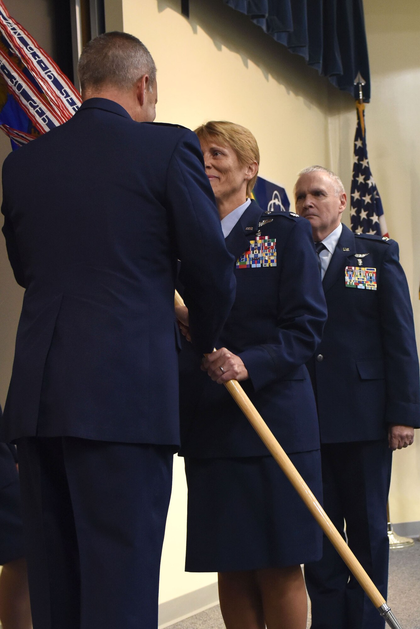 Lt. Col. Julie Carpenter (center), the new 193rd Special Operations Medical Group commander, accepts the guidon from Col. Mike Cason, 193rd Special Operations Wing commander, during a change-of-command ceremony Aug. 14 at Middletown, Pennsylvania. Carpenter succeeds Col. David Gann (right), who retired from the position and the Air National Guard. The ceremony began with preliminary honors and ended with the symbolic passing of the guidon. (U.S. Air National Guard photo by Airman 1st Class Julia Sorber/Released) 