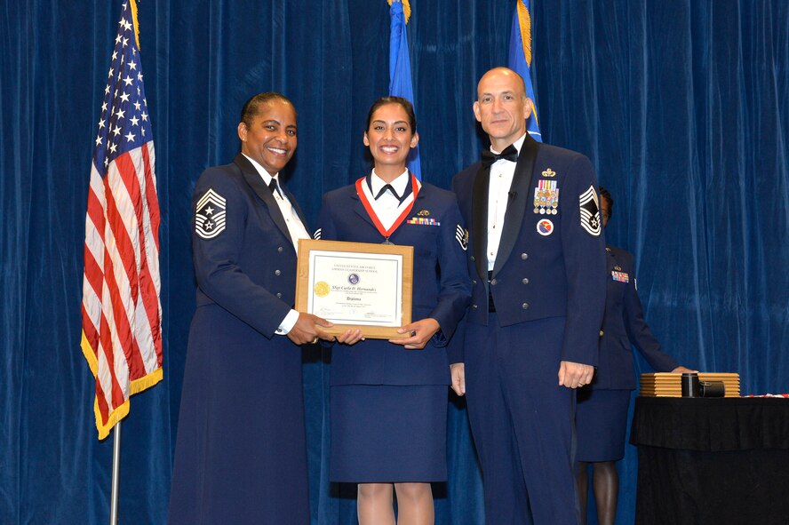 Staff Sgt. Carla Hernandez, right, receives the Distinguished Graduate Award for Airman leadership school class 16-7 from Chief Master Sgt. Shelina Frey, Command Chief Master Sgt. of Air Mobility Command, and Chief Master Sgt. Edward Walden, Sr., Commandant of the Paul H. Lankford Enlisted PME Center, here, Aug. 11, 2016, at the I. G. Brown Training and Education Center. The distinguished graduate award is presented to students in the top 10 percent of the class. (U.S. Air National Guard photo by Master Sgt. Jerry D. Harlan/Released)