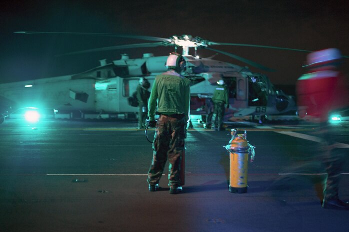 Sailors conduct flight operations with a MH-60S Sea Hawk on the flight deck of the USS Bonhomme Richard in the East China Sea, Aug. 12, 2016. The Richard is supporting security and stability in the Indo-Asia-Pacific region. Navy photo by Petty Officer 3rd Class Jeanette Mullinax